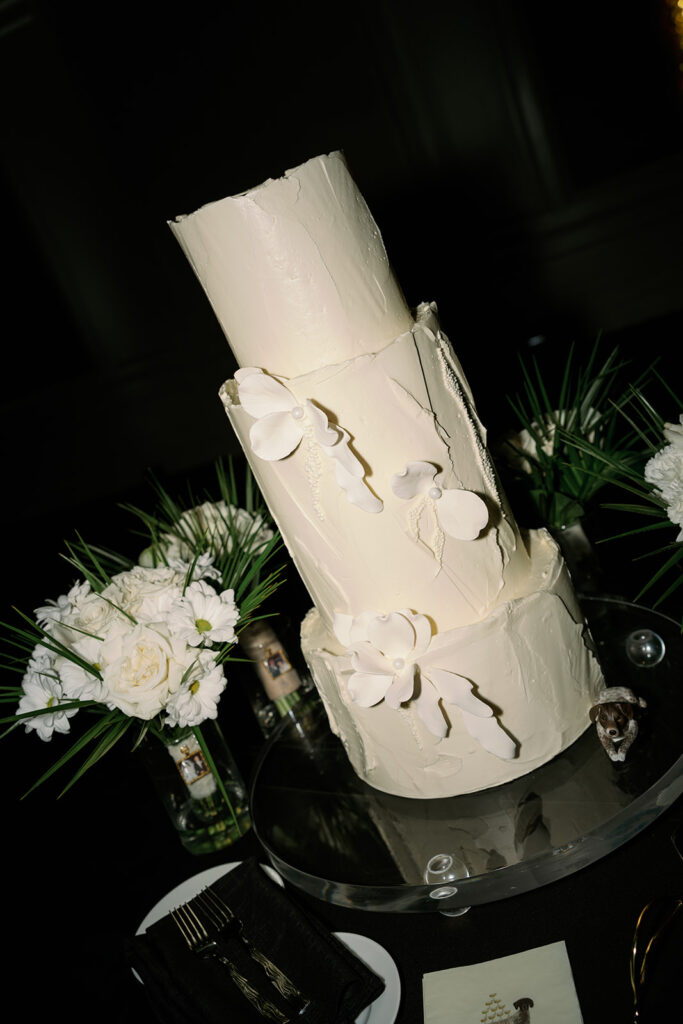 Tall, three tier modern white wedding cake